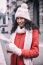 Beautiful Woman In Red Coat And Wool Cap And Gloves With Smartph