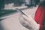 Woman In Red Coat With Smartphone In Hands Going Through The Cit