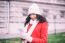 Beautiful Woman In Red Coat And Wool Cap And Gloves With Smartph