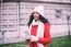 Beautiful Woman In Red Coat And Wool Cap And Gloves With Smartph