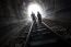 Couple Walking Together Through A Railway Tunnel