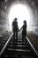 Couple Walking Together Through A Railway Tunnel