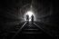 Couple Walking Together Through A Railway Tunnel