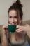 Woman With Coffee Cup On Ceramic Table And Mobile Phone