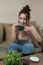 Woman With Coffee Cup On Ceramic Table And Mobile Phone