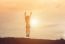 Silhouette Of Woman Jumping Against Beautiful Sky Background