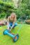 Young Dutch Woman Reparing Lawn Mower In Garden