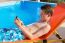 Youngster Operating Mobile Phone At Swimming Pool