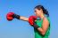 Young Woman Wearing Red Boxing Gloves With Blue Sky