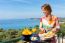 Dutch Woman Eating Breakfast With Sea Background