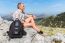 Caucasian Man Sitting With Backpack In Greek Mountains