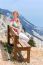 Caucasian Woman Sitting On Bench In Mountain Landscape