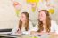 Two Female  Students In Classroom With  World Chart