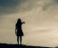 Silhouette Of Woman Praying Over Beautiful Sky Background