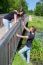 Young Man Offers Red Rose To Attractive Girl On Bridge