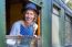 Dutch Woman In Old-fashioned Clothes In Window Of Steam Train