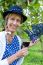 Woman Holding Glass Of Wine Near Bunch Of Blue Grapes