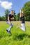 Young Dutch Couple Jumping In Green Meadow