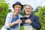 Caucasian Couple Toasting With Glasses Of Red Wine In Vineyard