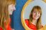 Portrait Of Redhead Girl Looking In Mirror