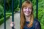 Redhead Girl Laughing Holding Bar Gate