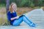 Dutch Girl Reading Book On Wooden Path In Forest