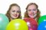 Two Girls Behind Various Colored Balloons