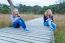 Two Girls Operating Mobile Phones In Nature