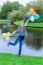 Girl Standing At Pond With Colored Balloons