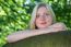 Blonde Girl Leaning On Branch In Nature