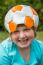 Young Girl Wearing Leather Football On Head