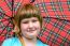 Young Blonde Girl Under Umbrella In Rain