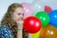 Teenage Girl Blowing Inflating Colored Balloons