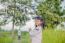 Girl Standing In The Field Of Rubber Happy