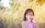 Adorable Little Girl Laughing In A Meadow - Happy Girl At Sunset