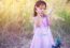 Adorable Little Girl Laughing In A Meadow - Happy Girl At Sunset