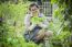 Asian Woman Planting Organic Vegetable In Home Garden