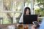 Young Asian Woman Working With Laptop In Coffee Shop