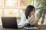 Young Businesswoman Working In Coffee Shop