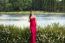 Beautiful Young Woman In The Gardens Wearing A Long Silk Red Dress