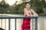 Beautiful Young Woman In The Gardens Wearing A Long Silk Red Dress