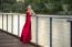 Beautiful Young Woman In The Gardens Wearing A Long Silk Red Dress