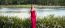 Beautiful Young Woman In The Gardens Wearing A Long Silk Red Dress