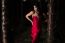 Beautiful Young Woman In The Gardens Wearing A Long Silk Red Dress