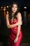 Beautiful Young Woman In The Gardens Wearing A Long Silk Red Dress