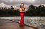 Beautiful Young Woman In The Gardens Wearing A Long Silk Red Dress