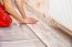 Young Handyman Installing Wooden Floor