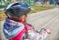 Little Girl In A Safety Helmet Riding A Bicycle