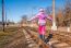 Little Girl Is Walking On Rails