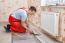 Young Handyman Installing Wooden Floor